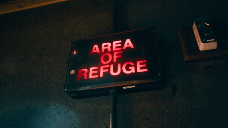 sign written "area of refuge" in red