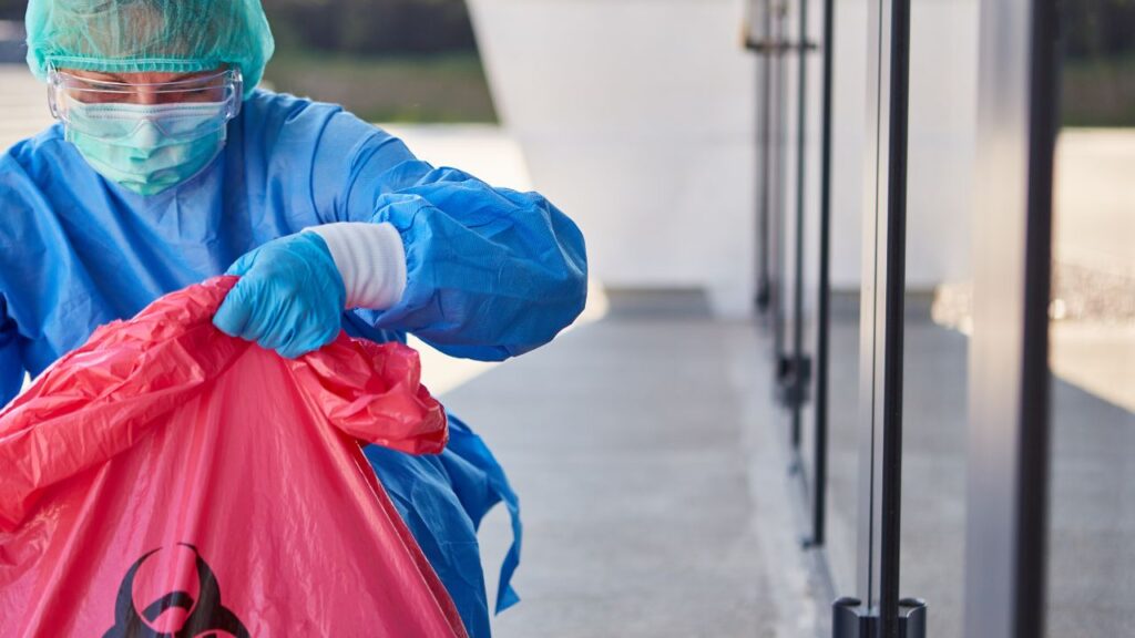 woman with a protective suit cleaning biohazard residues