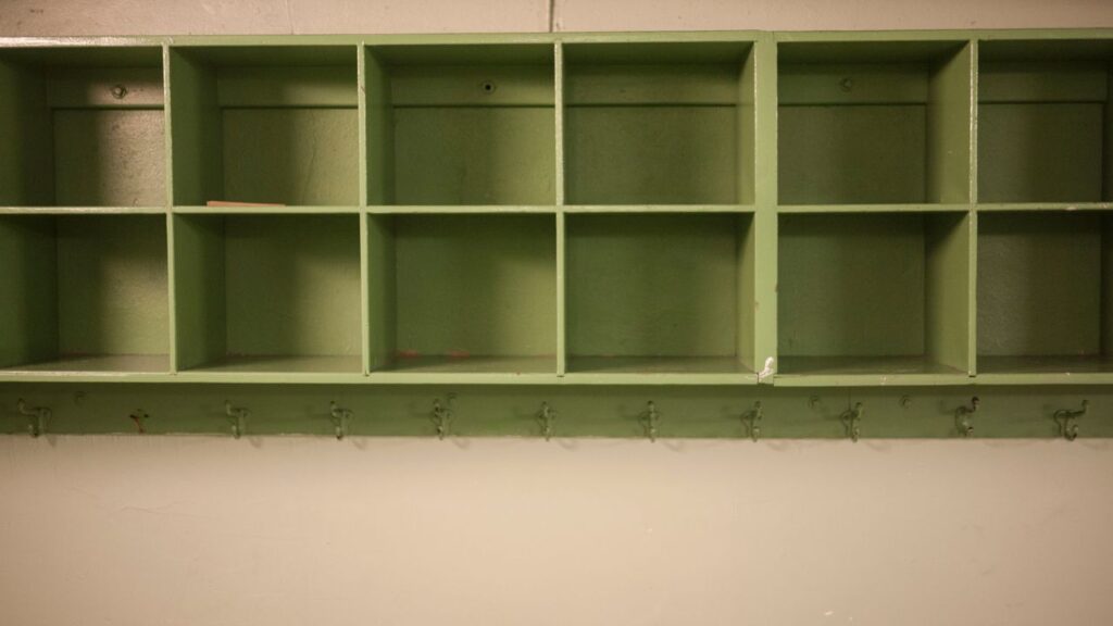 green cubbies in a creme wall to ensure a cleaner classroom removing clutter