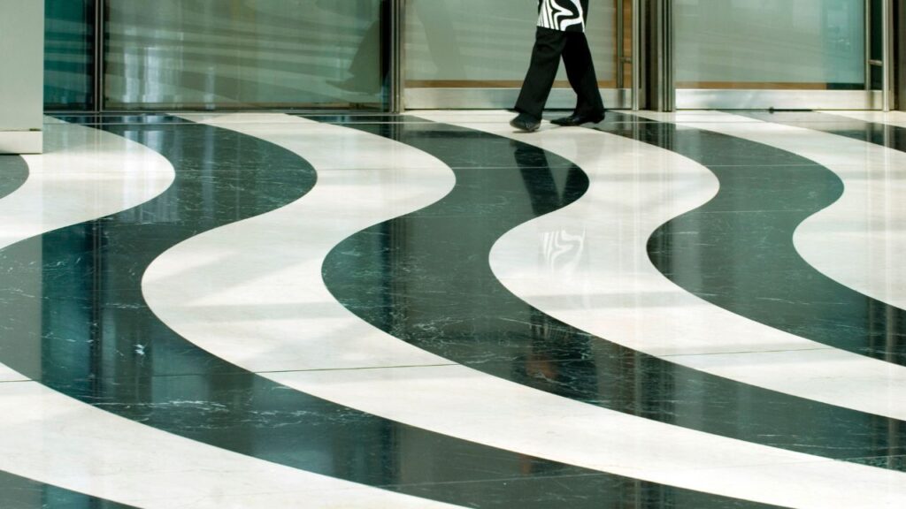 woman walking on squiggly black and white marble floor