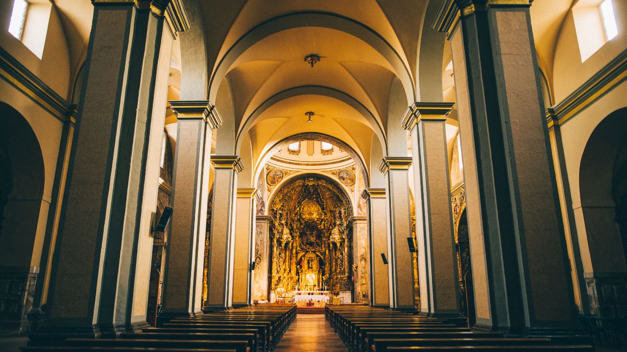 the inside of a church showing the pillars and altar showcasing the Importance of Cleaning High-Touch Surfaces in Churches