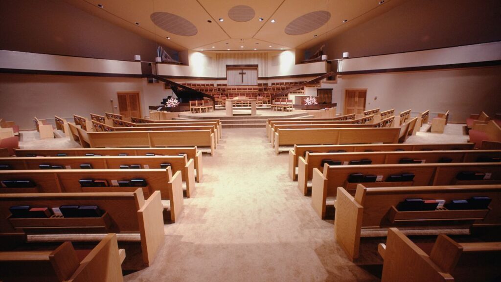 image of rows of pews in a church with bibles resting on them