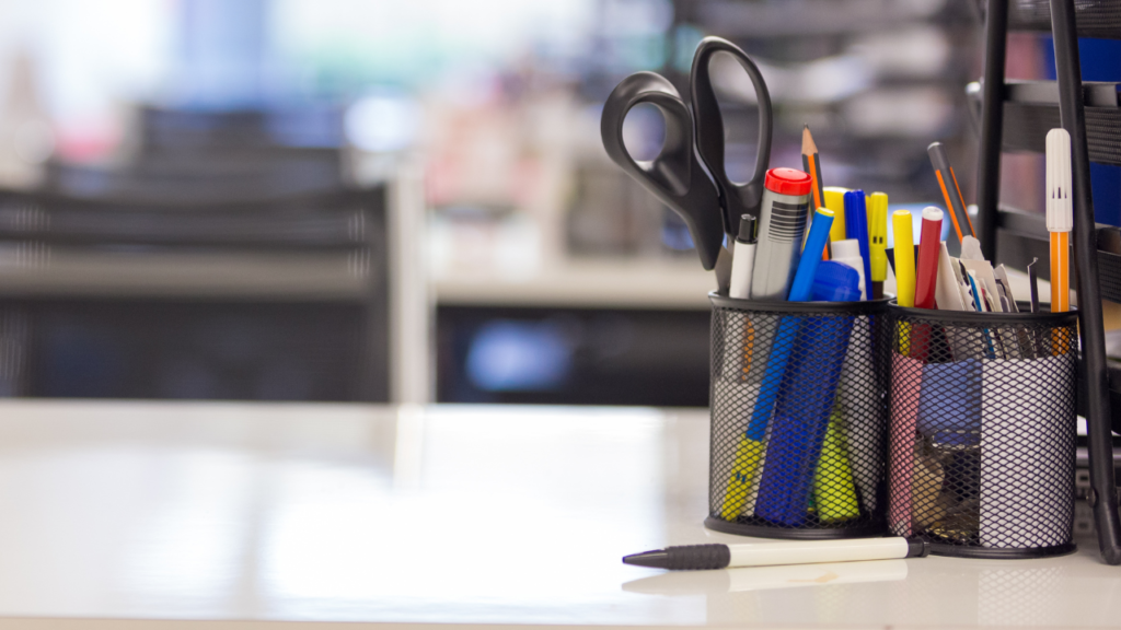 pen holder with multiple office supplies, such as different colored pens, scissors and pencils