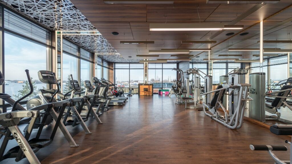 fitness studio space cleaning with equipment for cardio such as bikes with surrounding floor to ceiling windows