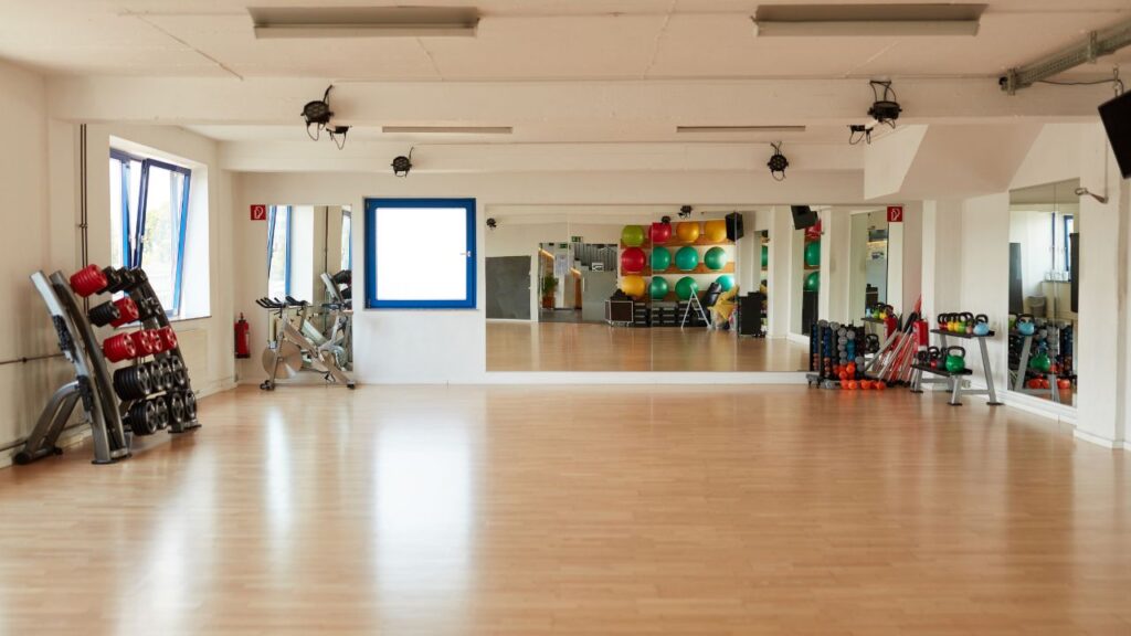 fitness studio space with a mirror and equipment