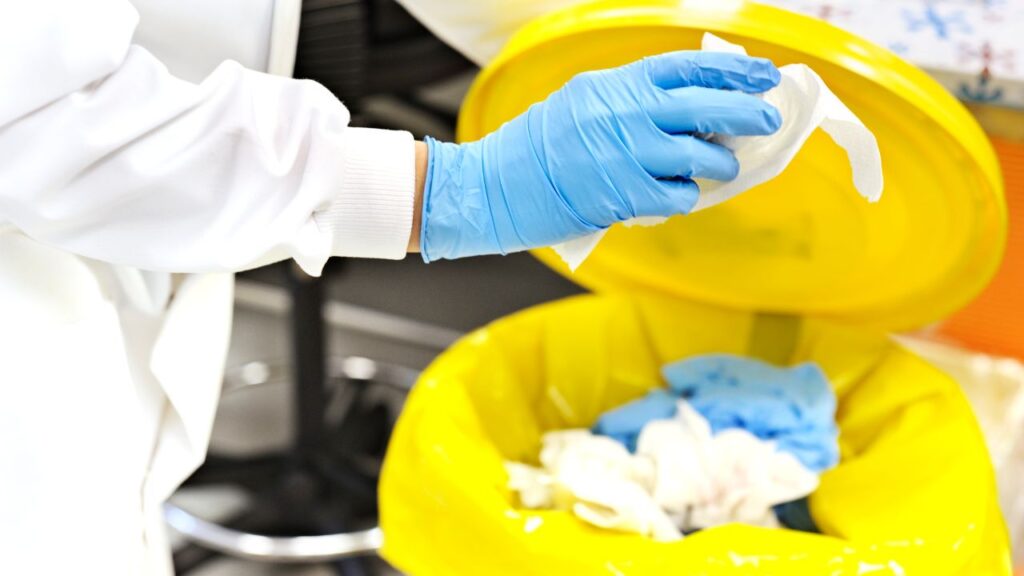 image of a person cleaning out trash from an office