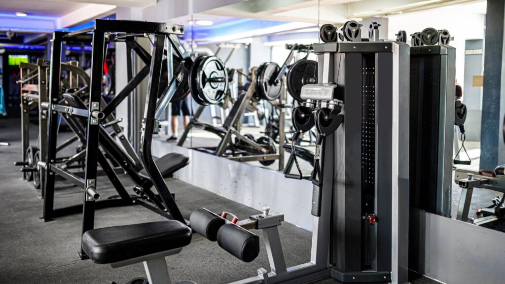 gym equipment for arm-exercises with a mirror behind them