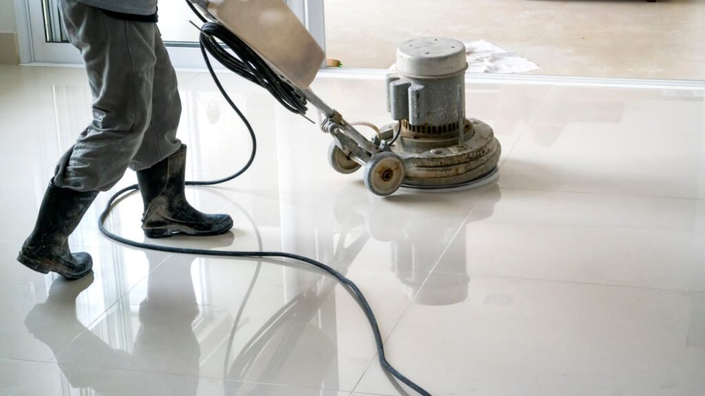 man scrubbing a marble floor with a scrubber showing the best practices for school cleaning