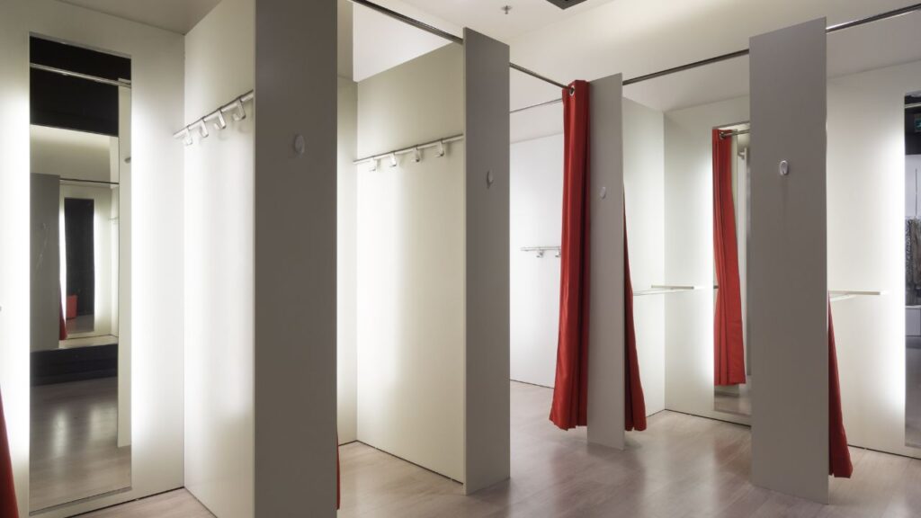 clothing store changing rooms with red curtains