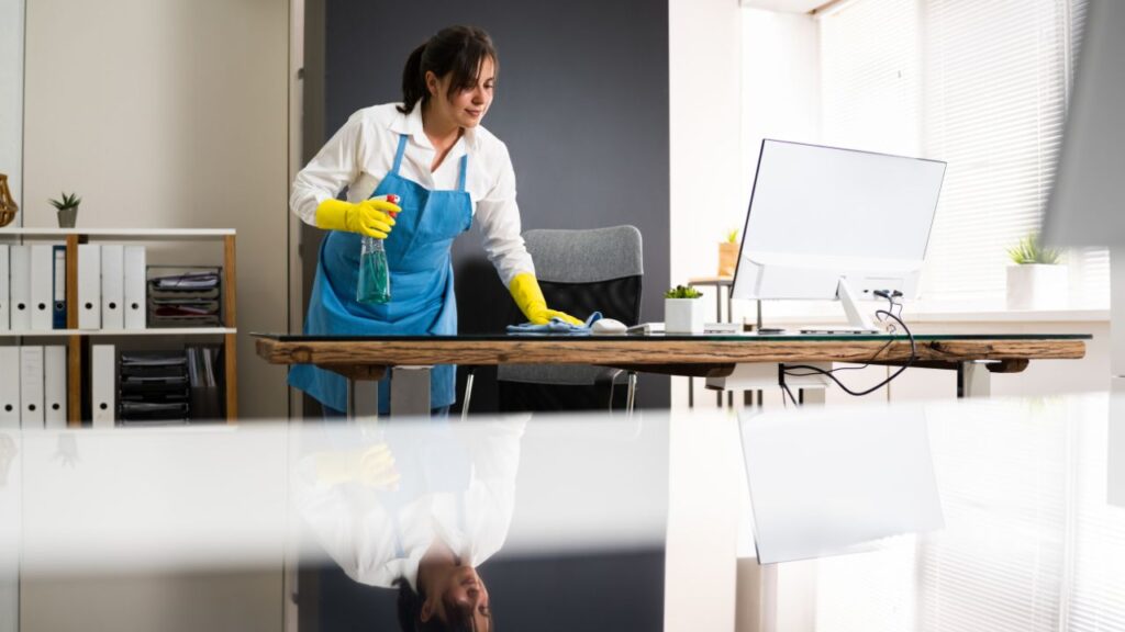 cleaning staff wiping office desk