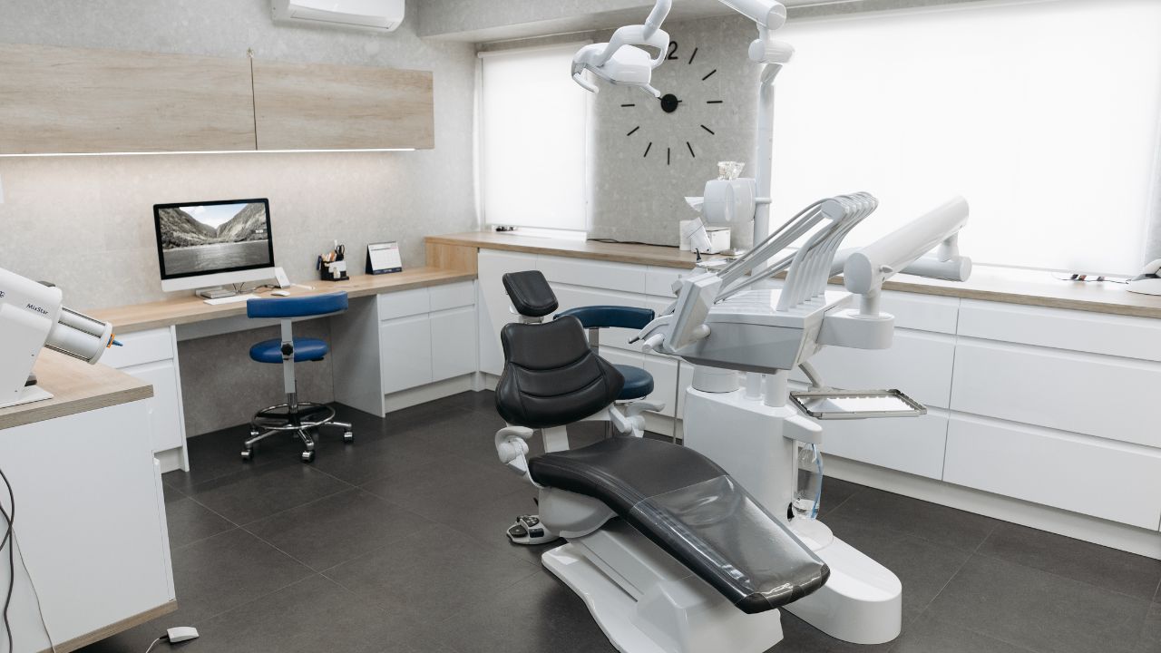 dental clinic space with white cabinets and black dentist chair